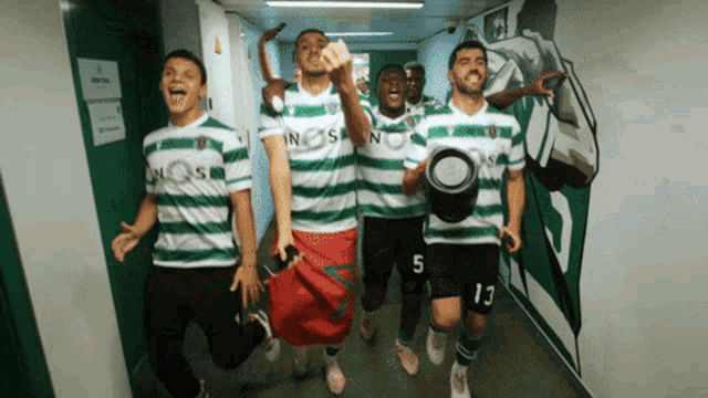 a group of soccer players are walking down a hallway with nos on their jerseys