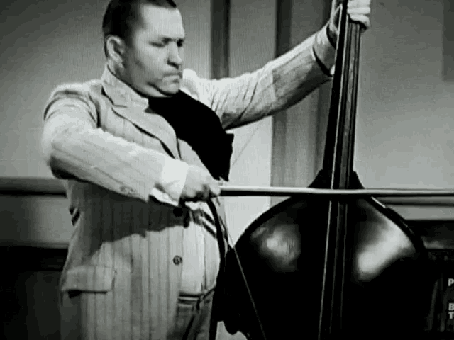 a black and white photo of a man playing a violin