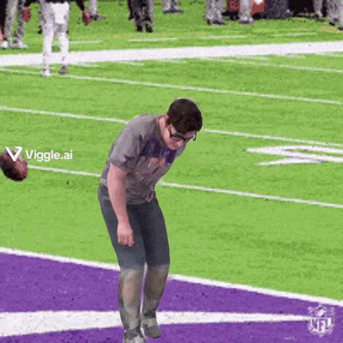 a man standing on a football field with a viggle.ai logo in the corner