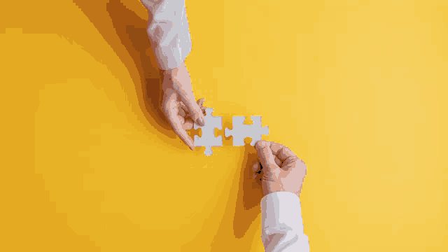 a man and a woman are holding pieces of a puzzle together on a yellow background