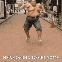 a shirtless fat man is running down a street and says `` he 's coming to get some '' .