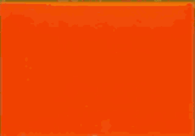 a man in a suit and tie is sitting in front of a wall .