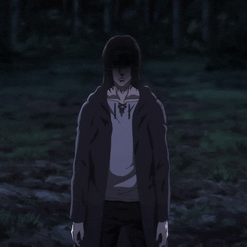 a man in a hooded jacket is standing in a dark field