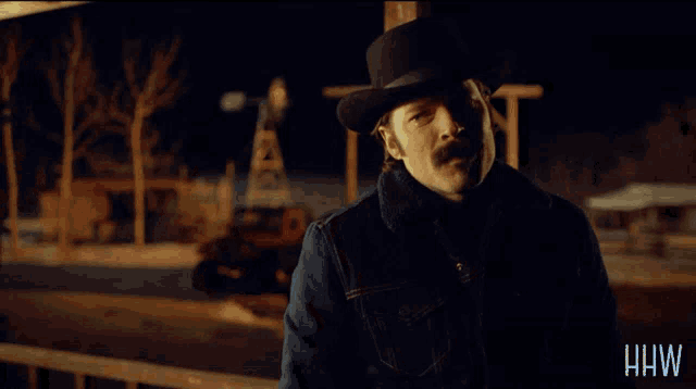 a woman with long red hair is standing in front of a sign that says you 're not welcome in my home anymore