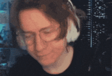 a close up of a person wearing headphones with their eyes closed