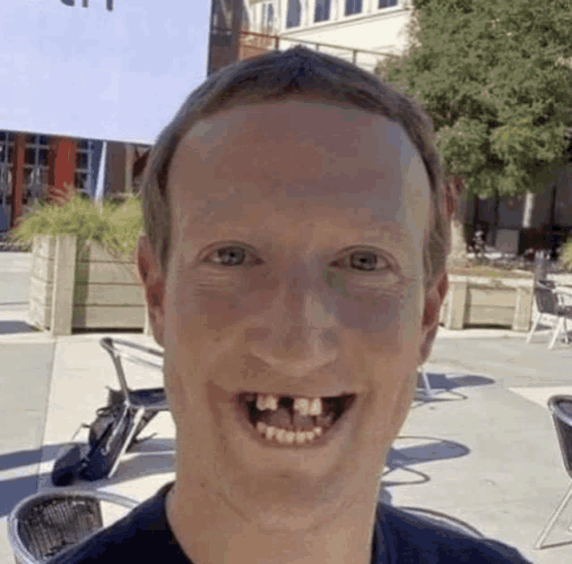 a man with missing teeth is smiling for the camera while standing in front of a building .