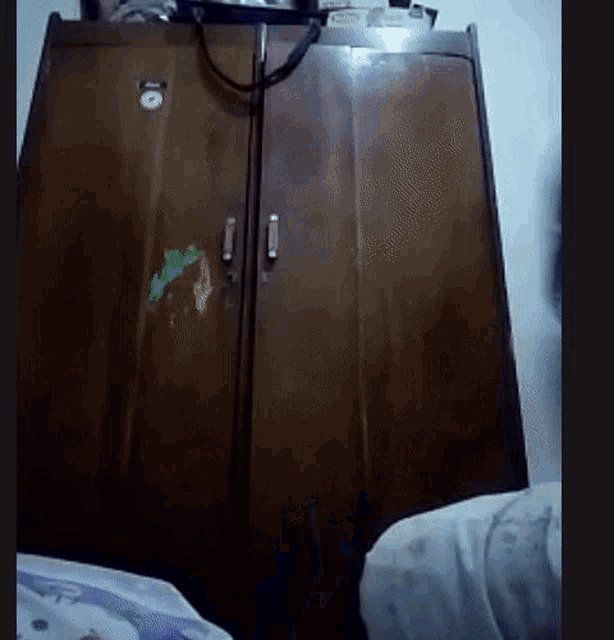 a wooden wardrobe with a sticker on it that says ' i '