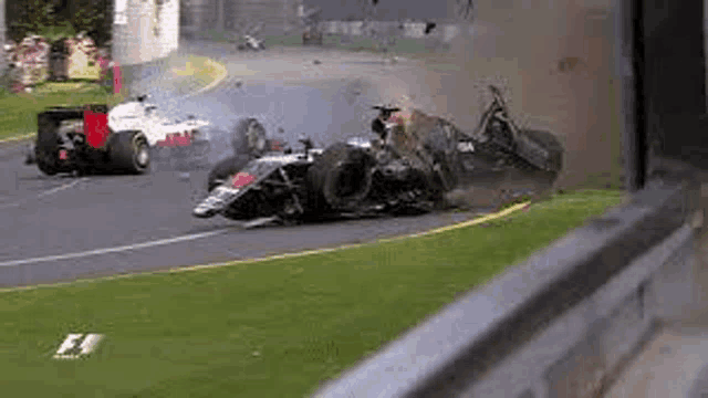 a race car is crashing on a race track .