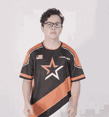 a young man wearing glasses and a shirt with a star on it