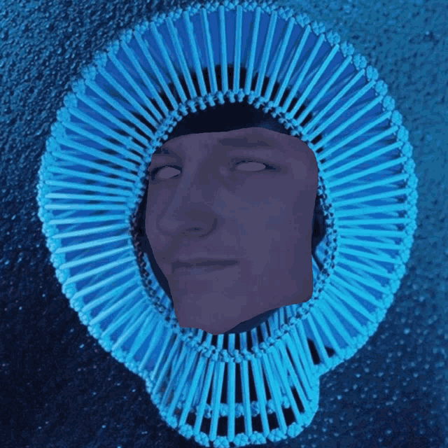 a person 's face is visible through a blue circle