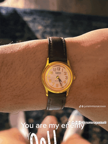 a guess watch on a person 's wrist