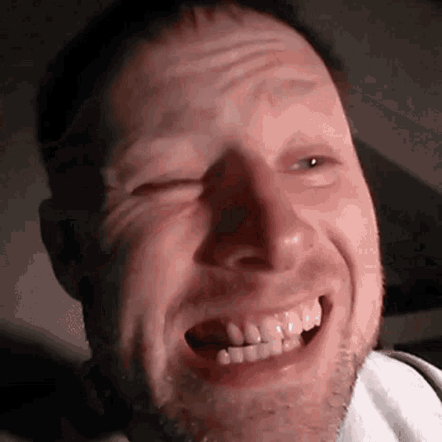 a close up of a man 's face with his mouth open