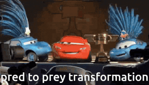 a group of cars from the movie cars are sitting on a table next to a trophy .