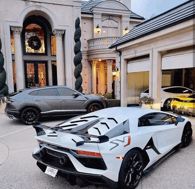 a white lamborghini aventador is parked in front of a mansion .