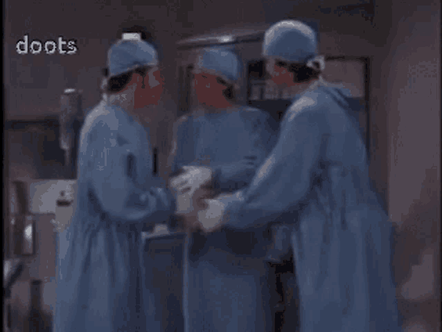 a group of surgeons are standing in an operating room with the word doots visible in the corner