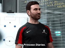 a man standing in front of a white board with the words the princess diaries written on it