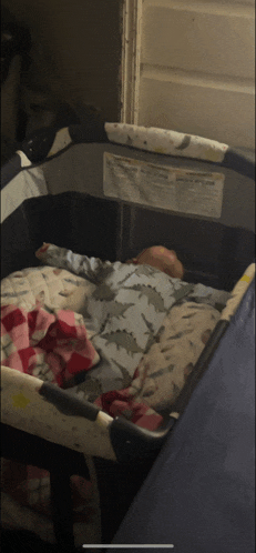 a baby is sleeping in a crib with a warning label on the side