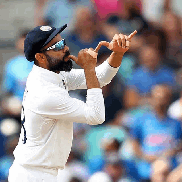 a bearded man wearing a white shirt and a black hat with the number 8 on it