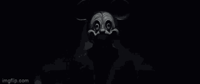 a black and white drawing of a mickey mouse in the dark