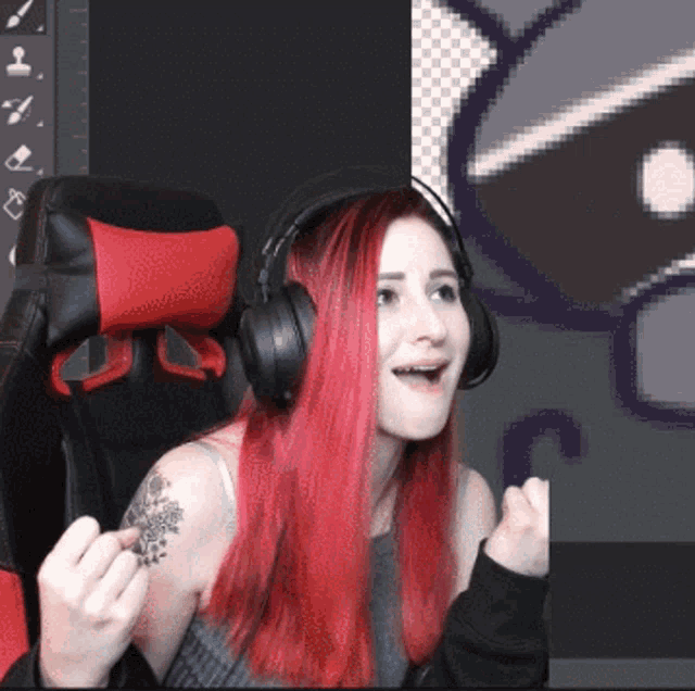 a woman with red hair is wearing headphones in front of a computer screen