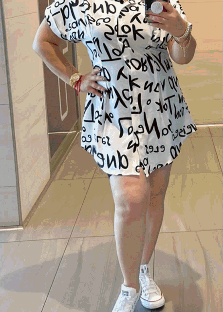 a woman is taking a picture of herself in a mirror wearing a shirt that says " i love you " on it