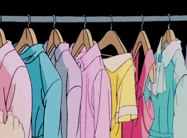 a bunch of clothes are hanging on a rack with a black background