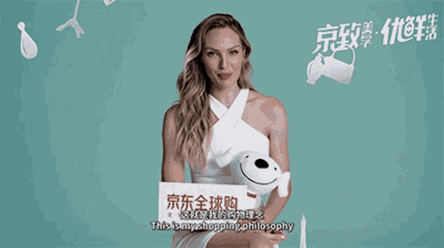 a woman in a white dress is holding a stuffed animal in front of a sign that says follow me at gerber