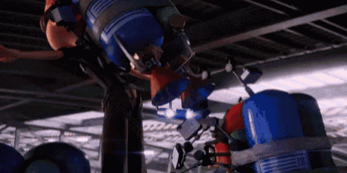 a person is riding a roller coaster with a bunch of balloons hanging from the ceiling .