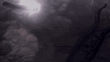 the sun shines through the clouds in a dark room