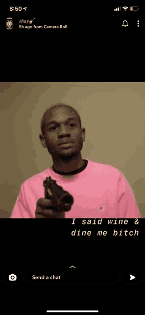 a man in a pink shirt is holding a gun and says i said wine & dine me bitch