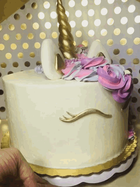 a unicorn cake with purple and blue frosting on it