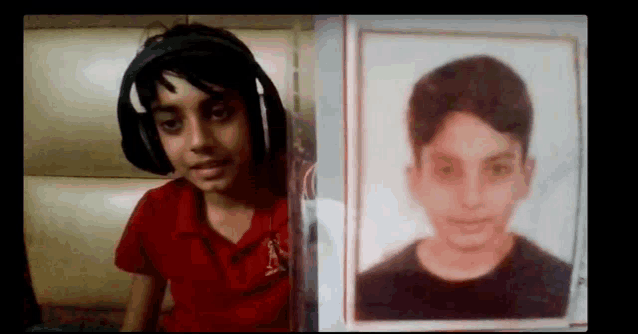 a young boy wearing headphones is holding a picture of himself in front of him .