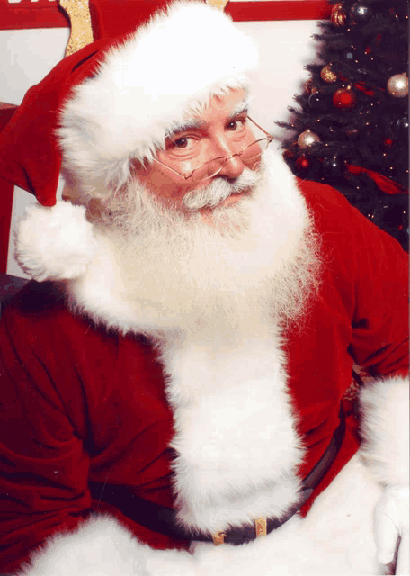 a man dressed as santa claus with a beard and glasses