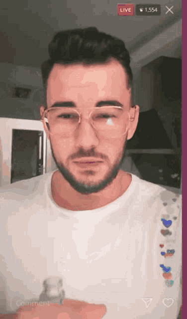 a man wearing glasses and a white shirt is being live streamed on instagram