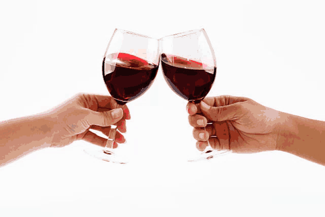 two hands toasting with wine glasses filled with red wine