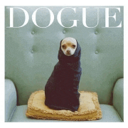 a small dog is wrapped in a black blanket on the cover of a dogue magazine