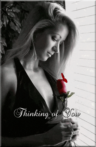 a black and white photo of a woman holding a rose with the words " thinking of you " on the bottom