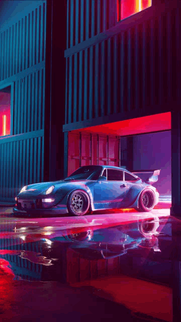 a blue sports car is parked in front of a building at night