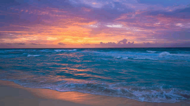 a sunset over the ocean with a purple sky