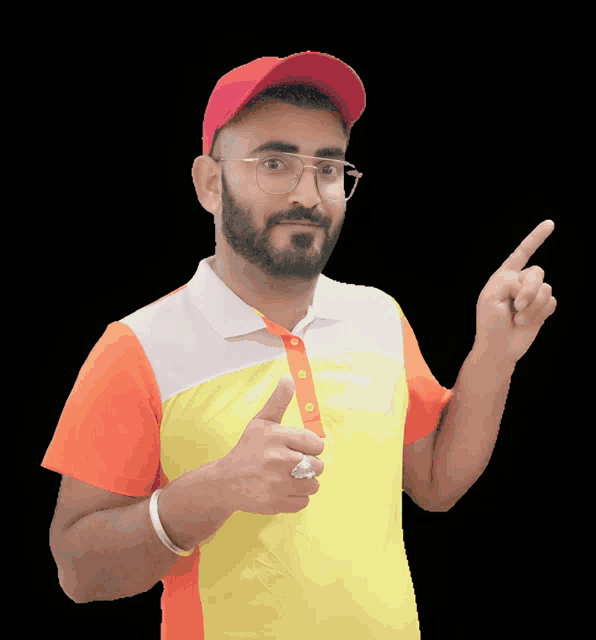 a man wearing a red hat and glasses is pointing upwards