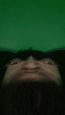 a blurry picture of a person 's face against a green background