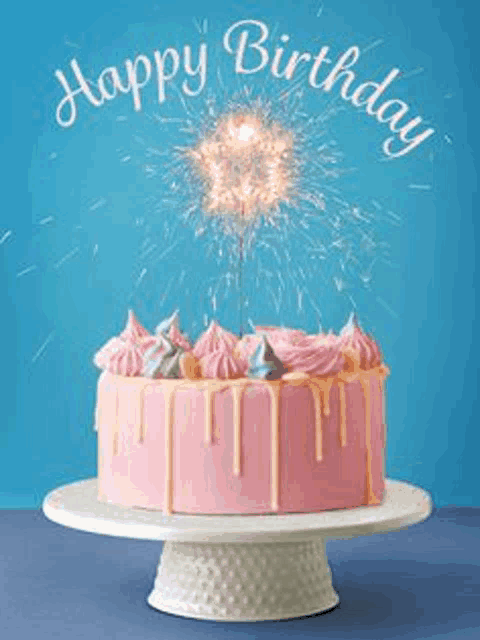 a pink birthday cake with sparklers on top is on a cake stand .