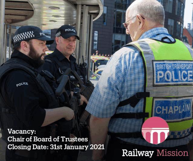 a british transport police officer talks to a man