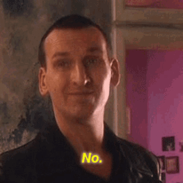 a man in a black jacket with the word no on his neck