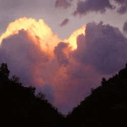 a heart shaped cloud in a sunset sky