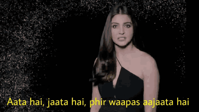 a woman in a black dress says aata hai jaata hai