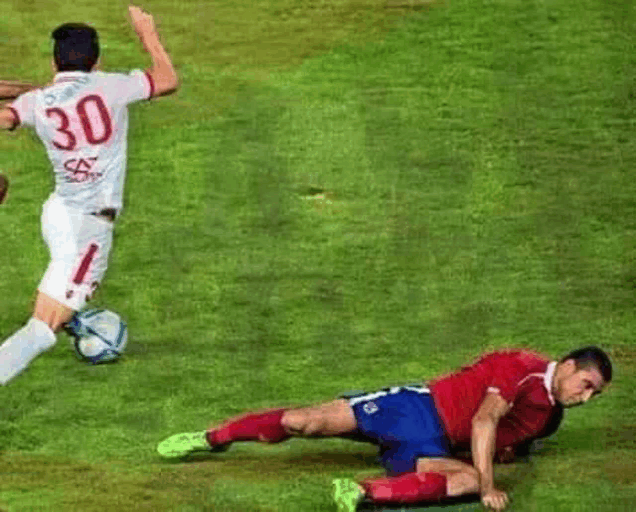 two soccer players are playing a game of soccer on a field . one of the players has the number 30 on his back .