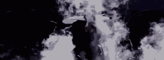 a person is standing in a dark room with smoke coming out of the ceiling .