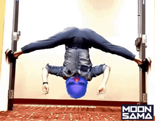 a person doing a handstand in front of a sign that says moon sama on it