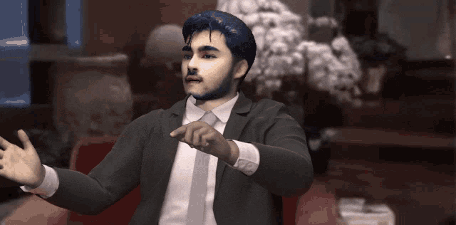 a man in a suit and tie is making a gesture